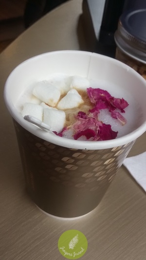 White coffee Nescafe Gold with toppings of rose petals and marshmallows